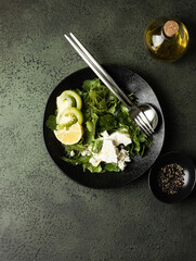 flat lay green spring salad with cheese and olive oil