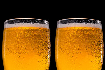 Glasses of beer on black background. Close up