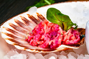 Ceviche. Finely chopped raw tuna and salmon marinated in lemon juice served in seashell.