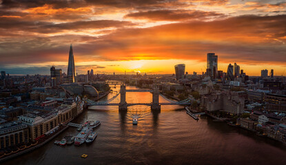 Aerial view of colorful sunset behind the modern skyline of London, United Kingdom, along the...