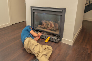 Service technician working on a fireplace