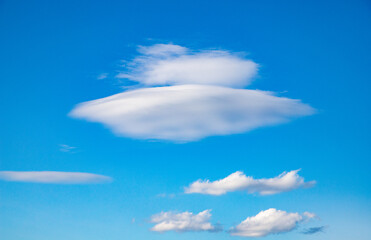 Fototapeta na wymiar flying saucer shaped white cloud