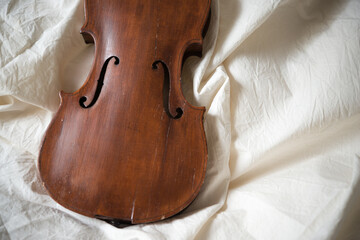 old, soundless violin with missing strings, fingerboard, sounding post, bridge, chin rest, and tail...
