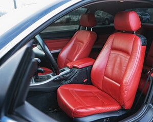 Luxury car interior with red leather seats and black details