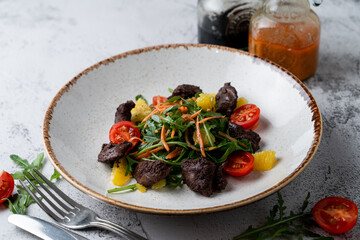 Italian liver salad with grated carrot, mixed greens and orange slices, modern cuisine, recipe book photo
