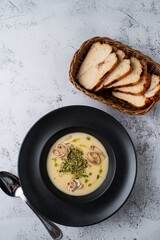 Cheese creamy soup with fettuccine and grated pistachios, top view