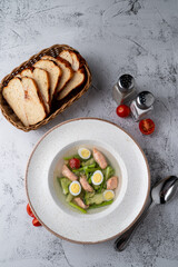 Zero calorie, diet soup with salmon, eggs and broccoli, protein soup top view on a stone table