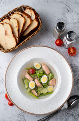 Zero calorie, diet soup with salmon, eggs and broccoli, protein soup top view on a stone table