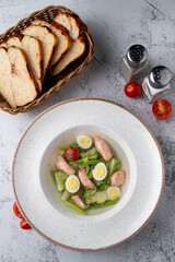 Zero calorie, diet soup with salmon, eggs and broccoli, protein soup top view on a stone table