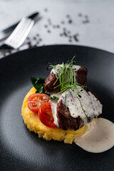 Nourishing restaurant meal: mashed potato with filet mignon and creamy garlic sauce, close appetizing view