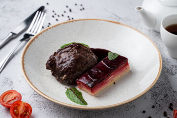 Sous vide beef cheeks garnished with beetroot and potato, side view