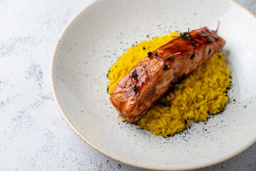 Top view of thick salmon steak with creamy lemon risotto, modern fusion cuisine, top view for a menu