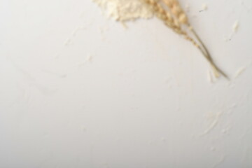 Flour, wheat, rice, raisins and coins on a white background