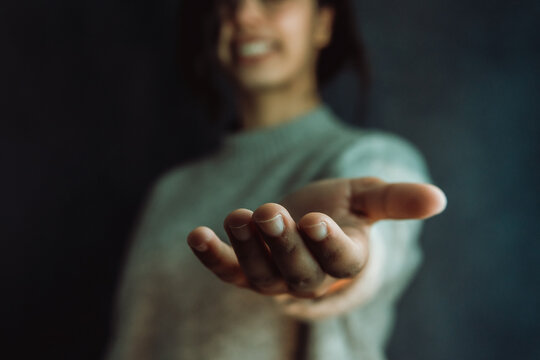 Woman giving hands to the camera, help and self help concept, mental health