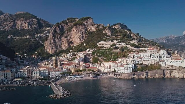 Cinematic drone shot flying over the wonderful town of amalfi.