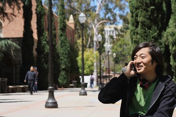 Japanese college student making a phone call on a mobile phone 