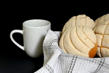 closeup of traditional Mexican vanilla shells in basket with white and gray cotton dishcloth next...