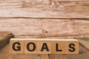 Wooden cubes with text GOALS. Motivational concept.