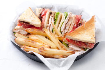 clubhouse sandwich with crispy fries