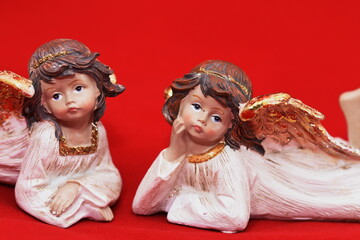 Ceramic angel figurine on a red background