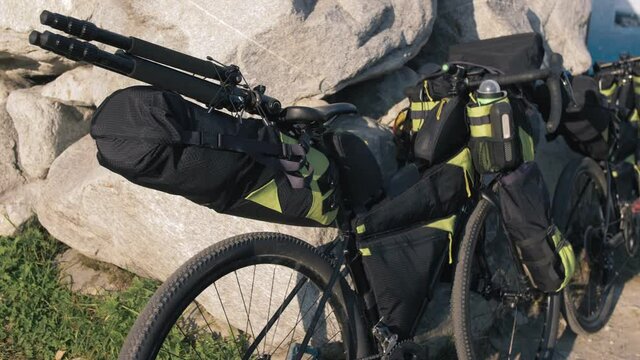 The mixed terrain cycle touring bike with bikepacking. The trip on multitrack bike, outdoor road in mountain snow capped.