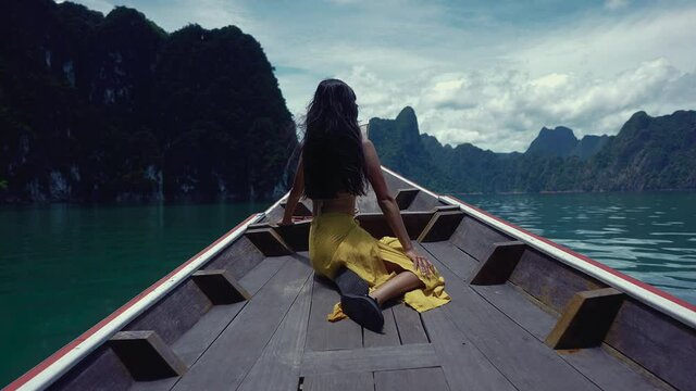 Cute Smiling Asian Sitting on a Long-Tail Boat in Cheow Lan Lake, Thailand.
