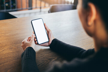cell phone blank white screen mockup.woman hand holding texting using mobile on desk at office.background empty space for advertise.work people contact marketing business,technology