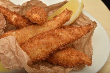 fish with flakes and French fries with mayonnaise and lemon
