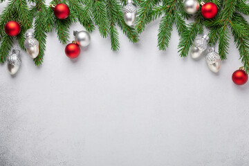 Christmas horizontal banner Fir tree branches with red and silver christmas balls on white backgroun