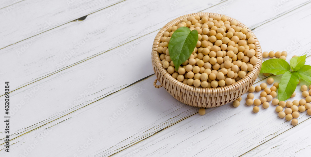 Wall mural soybean or soya bean in a bowl on white table background, healthy concept.