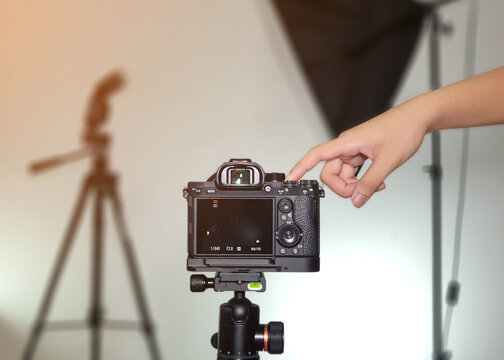 A cameraman taking a picture in a studio.