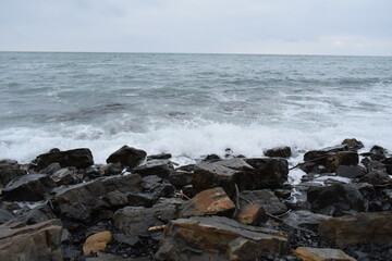 Fototapeta na wymiar Big waves on the Black Sea. Stone beach. The photo was taken near the resort town of Anapa.