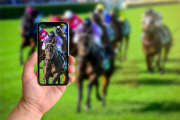 Man taking photo of horse racing