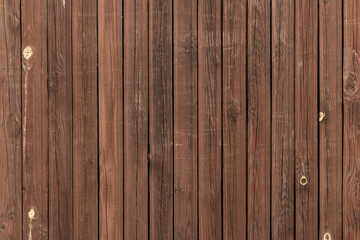 Naklejka premium Vintage fence made of narrow vertical boards painted in brown color