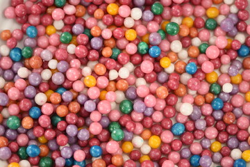 Fototapeta na wymiar Heap of sugared colorful sweet dragees as a background