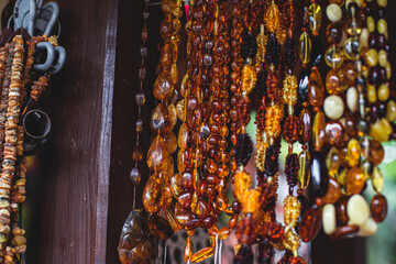 Variety assortment of souvenirs made of amber, traditional tourist souvenirs and gifts from Kaliningrad, Russia, in local vendor souvenir shop