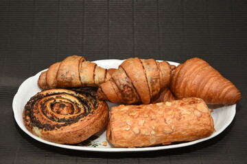 plate with croissants and strudel with almonds