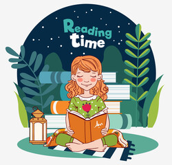 Cute, little girl reading a book in the garden