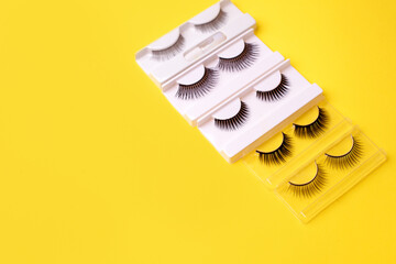 Set, collection of black false eyelashes on trendy bright yellow background, lashmaker concept,...