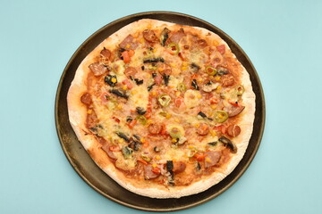 pizza with olives and cheese on  blue background
