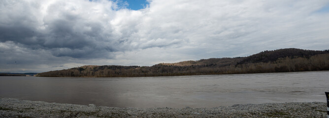 Panorama of early spring on the river bank on a stormy day