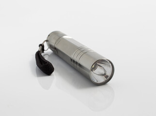 mini aluminum flashlight isolated on white