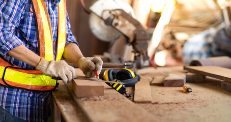 Close up hand of Asian elderly carpenter man working woodwork for home use. Construction industry...