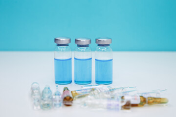 Medicine vials and syringe. Healthcare and medical concept. Covid-19 vaccination background. Coronavirus vaccine bottles and syringe injection. Doctor preparing the vaccine. A vaccine against disease.