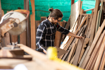 Carpenter woking at wood workshop. Construction industry concept. Tools for woodwrok pencil hammer meter and screw-driver.