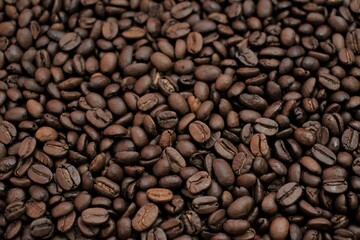 Coffee beans background. Roasted coffee close-up.Texture of coffee beans. space for text.Arabica and Robusta coffee variety.Traditional morning drink