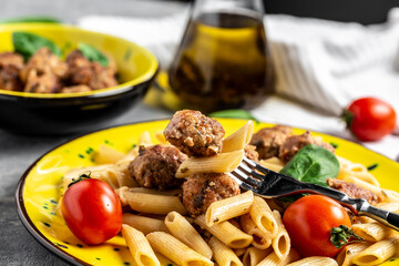 penne pasta with meatballs and tomato sauce, Food recipe background. Close up