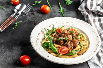 Italian pasta. penne pasta with meatballs in tomato sauce, top view