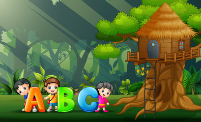 Happy kids holding ABC text in the park