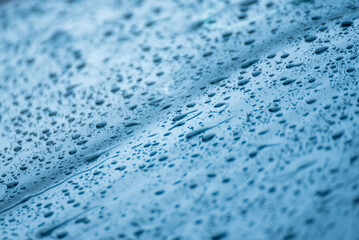 Obraz premium The day was heavy rain, the weather was overcast.Rain water falls on the windshield of car.